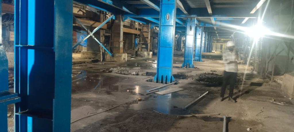 Industrial interior with steel columns and active floor preparation